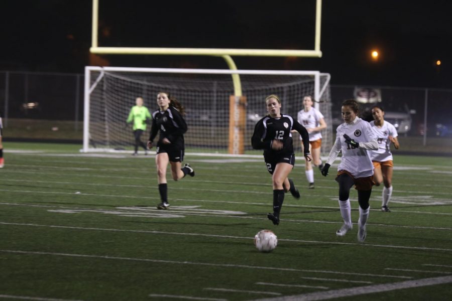 Hailey Martinez 21 sprints up the field and looks for a past. 