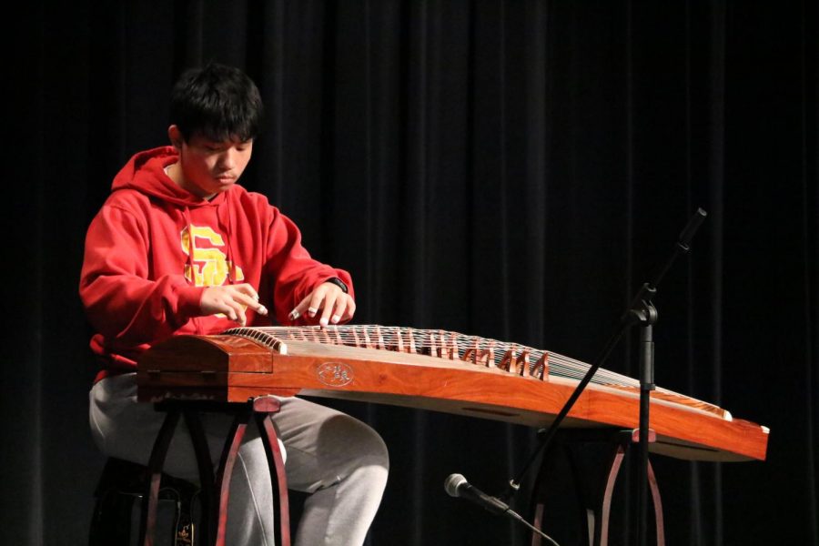 Kevin Li 18 plays the traditional Guzheng. 