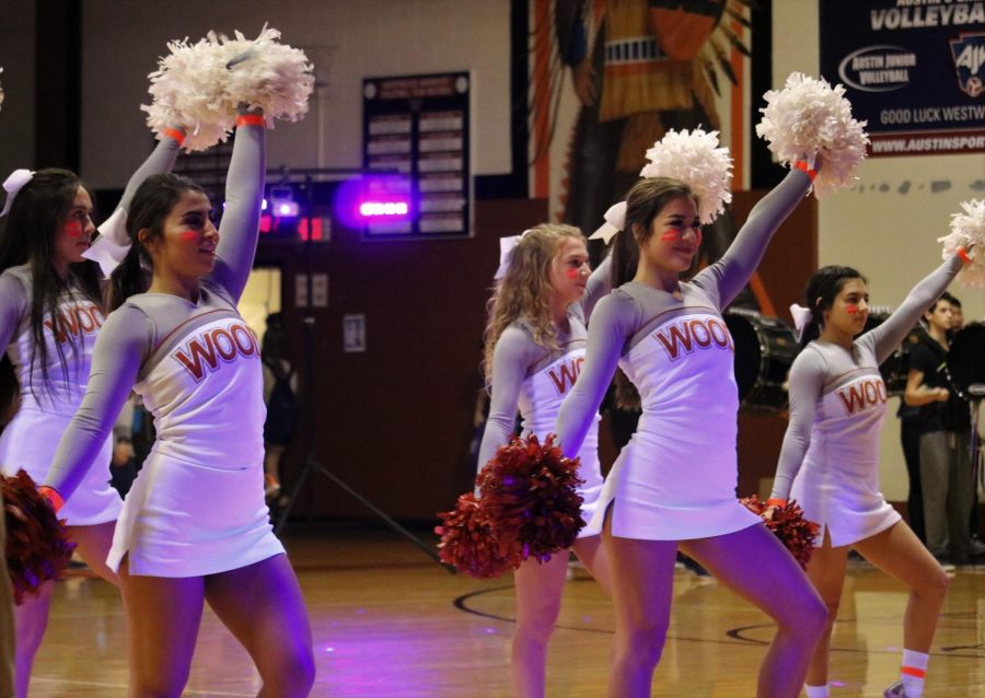 Cheerleaders welcome students into the gym.