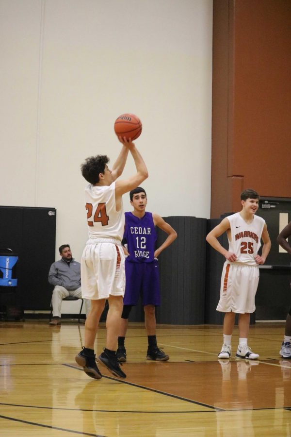 Luca Cipleu 21 shoots a free throw to score a point for the Warriors.