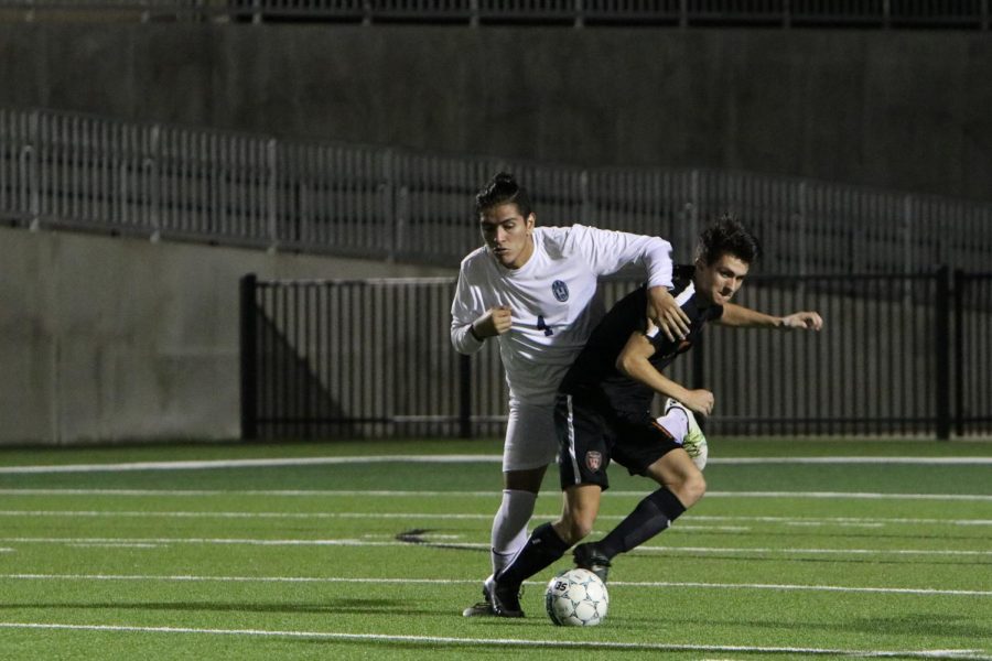 Caden Popps 18 fights to get ahead of a Hendrickson player to get the ball.