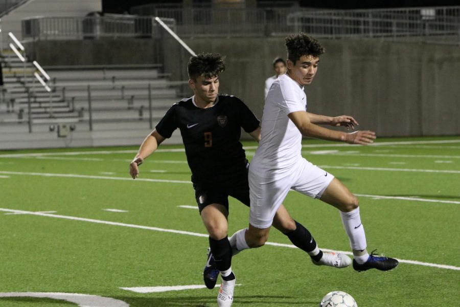 Felipe Centeno 19 looks for an opportunity to gain possession of the ball from a Hawks defender.