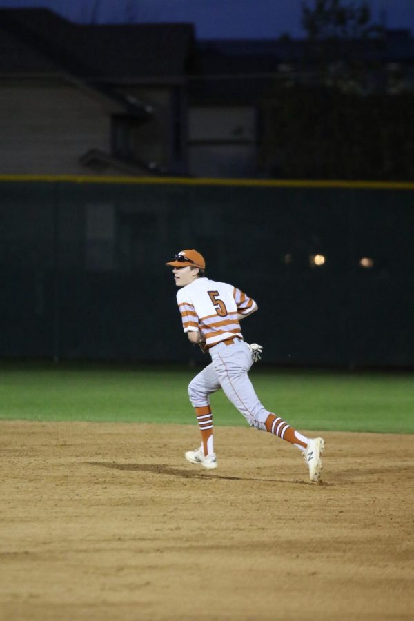 Cody Crider 20 makes a dash while following the ball in the outfield. 