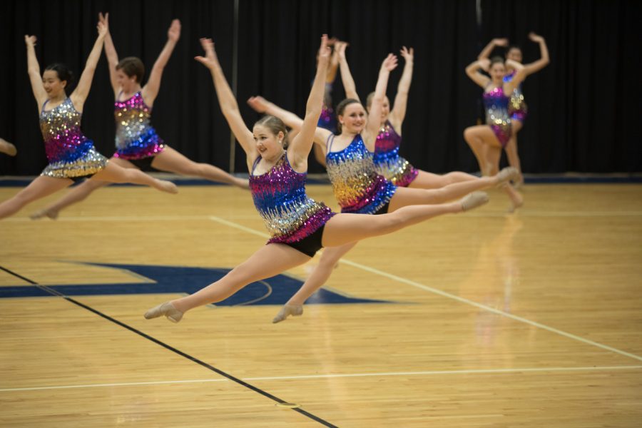 Jenna Weatherbie 18 executes a switch leap during the SunDancer team jazz.