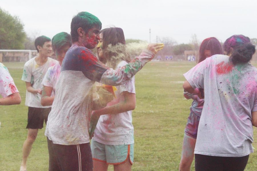 Students throw powder at their peers.