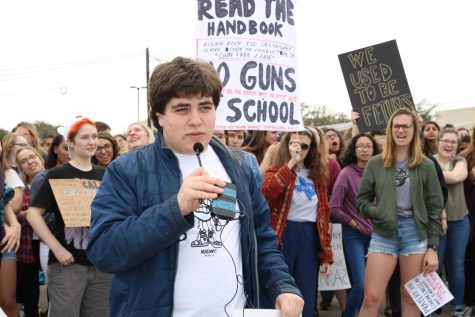 A student speaks into the microphone at the walkout. 