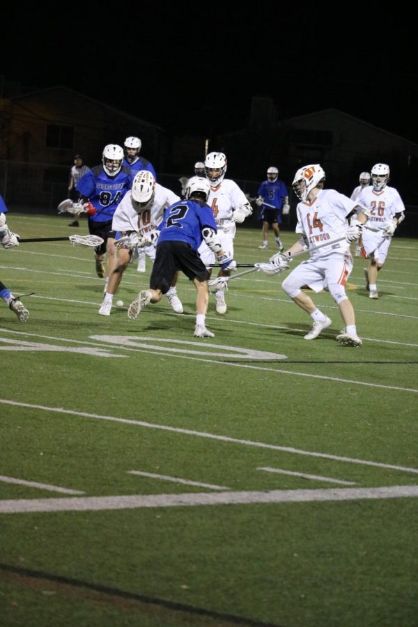 Ben Jensen 19, Braden Ross 18 and Miles Simpkins 18 surrounds a Georgetown player to win possession of the ball.