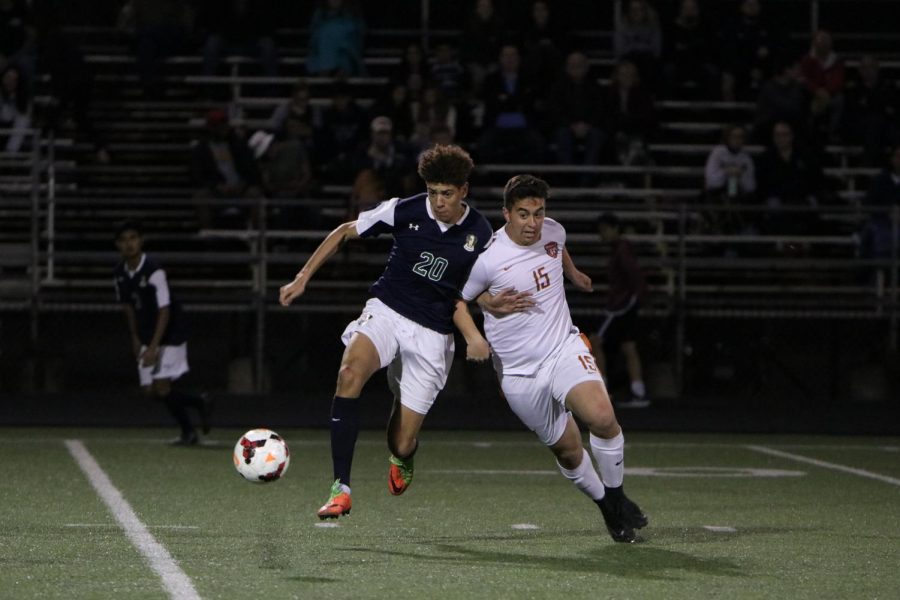 Evan Moreno 18 fights to stay ahead of a Mavericks defender to get to the ball.