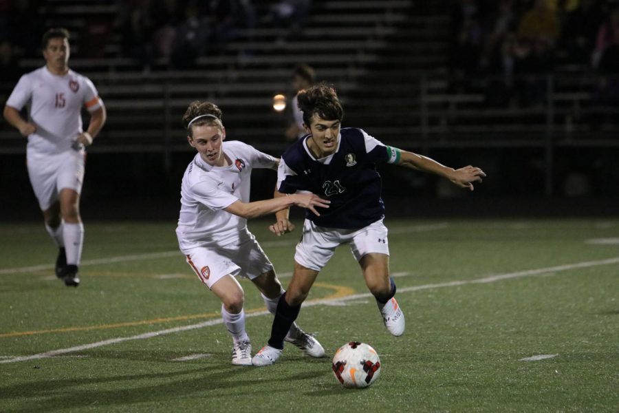Philip Richardson 20 quickly moves in to prevent a McNeil player from gaining possession of the ball.