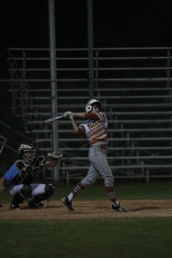 Trevor Borses 18 takes a swing to hit the ball.