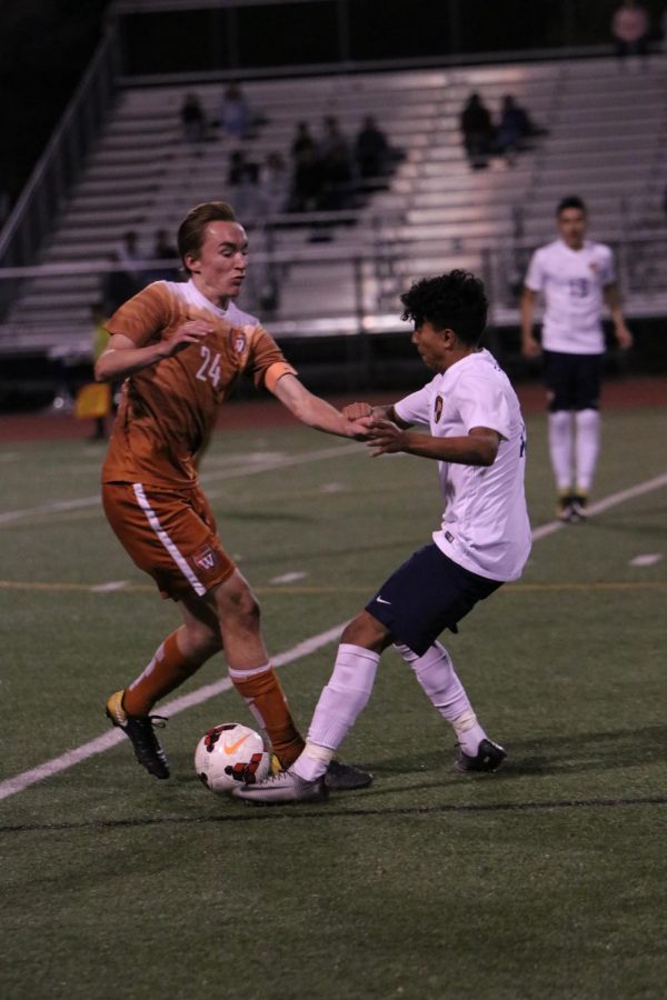Oliver Harris 18 fights to keep the ball in Warrior possession.