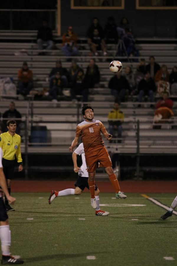 Lalo Rodriguez 19 jumps to head the ball.