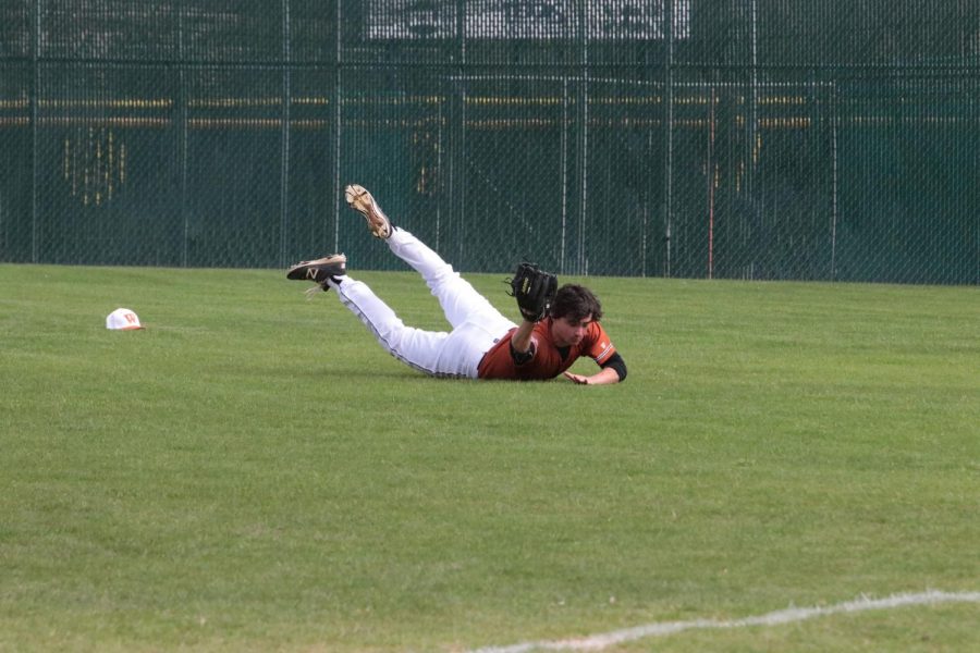 Trevor Borses 18 dives to catch the ball in the outfield.