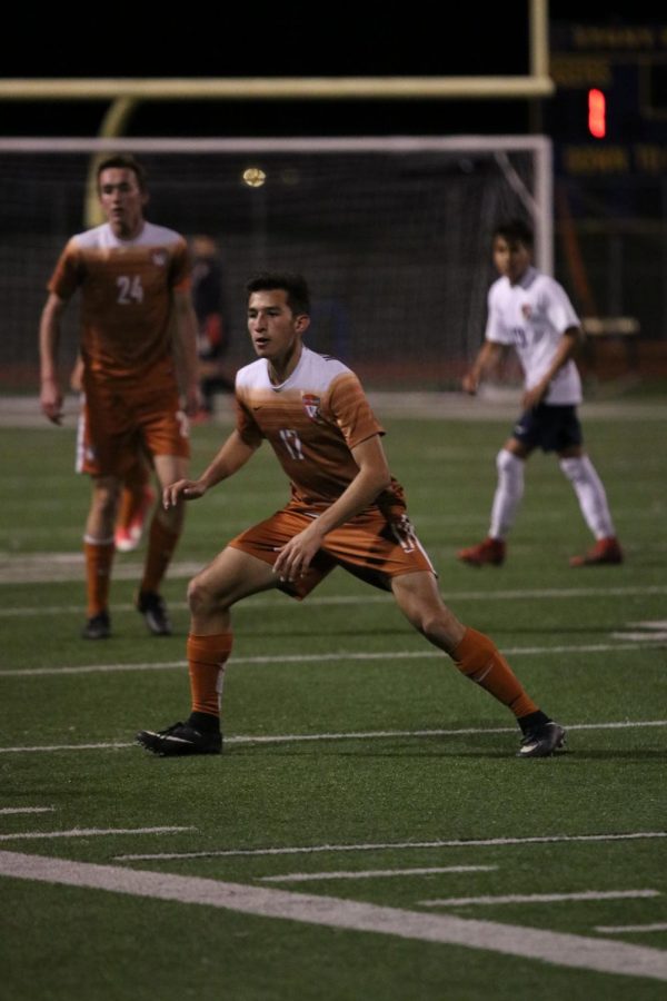 Carlos Lobera 18 looks in the direction of the ball before attempting to kick it away from a Stony Point player.