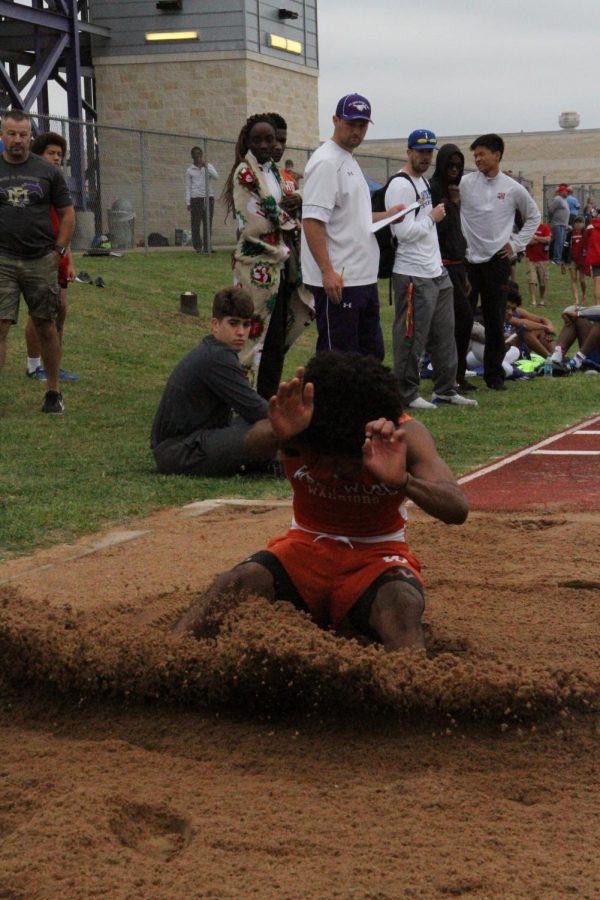 Malachi Woodard 20 jumping in the sand pit for long jump.