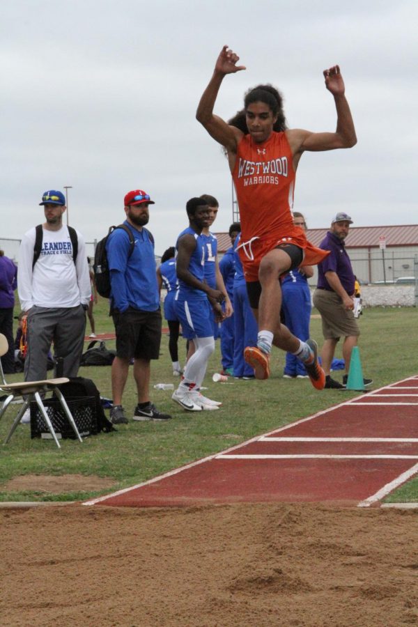 Nathaniel Lassalle 18 jumps in the sand pit for triple jump.