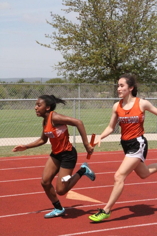 Junna Castel 20 passes the baton to Gabreauna Nash 21 in the 4x100-meter relay.
