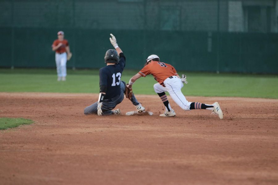 Cody Crider 20 tags a Hawk player to get him out before reaching second base.