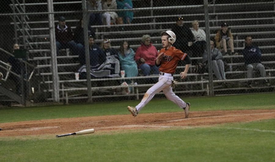 Marshall Dean 18 sprints to home plate to score.