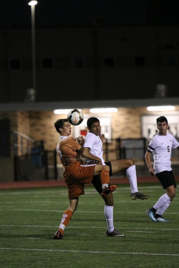 Caden Popps 18 attempts to kick the ball before a Pflugerville player.