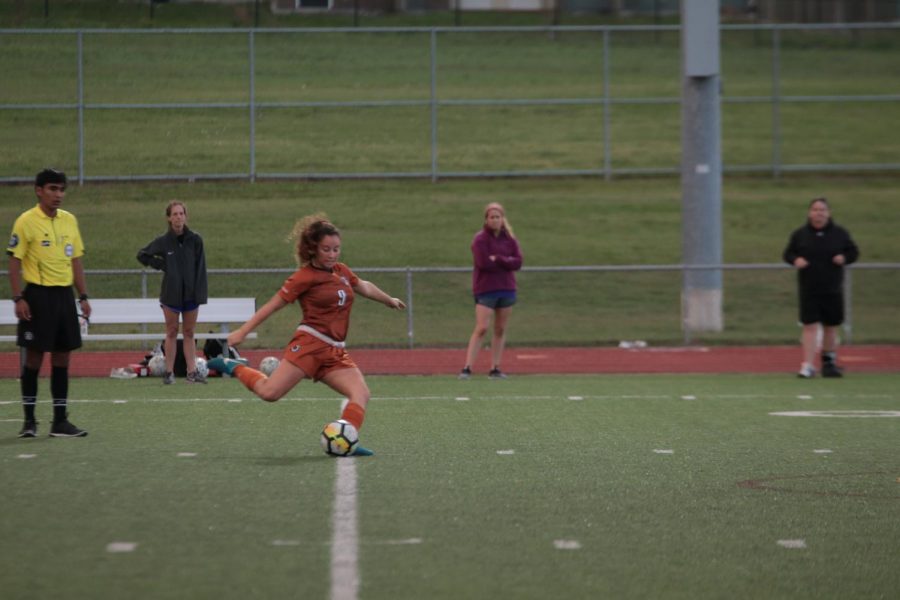 Leah Martinez 19 approaches the ball for a strong kick.