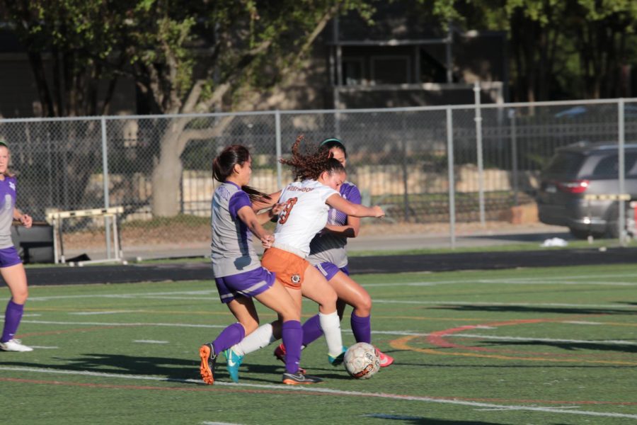 Leah Martinez 19 pushes past a Rattler defenders charge at the ball.