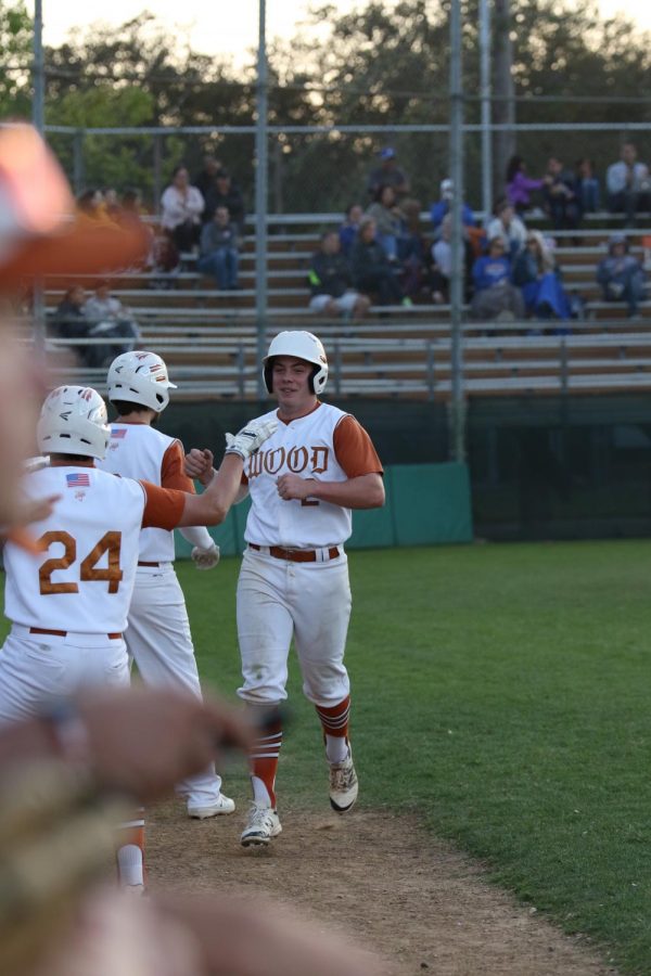 Reed Harrington 18 gets congratulated by his team mates after scoring a run for Westwood. 