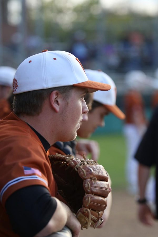 Kyle Clements 19 and his teammates watch as their team plays in the out field against Cedar Ridge.