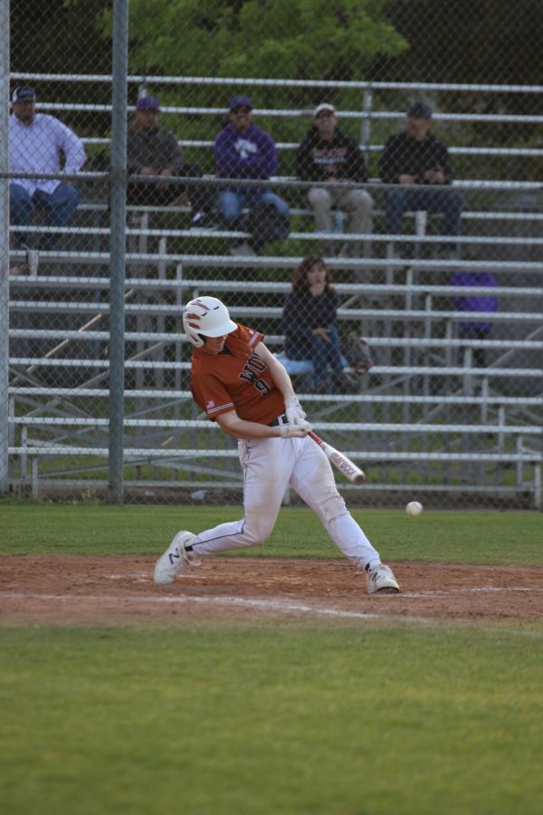 Ian Cox 19 swings and makes contact with a pitch from Cedar Ridge.