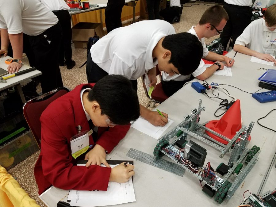 Avneesh Agarwal 19 and James Joh 19 take the technical standards test before showing off their robot.