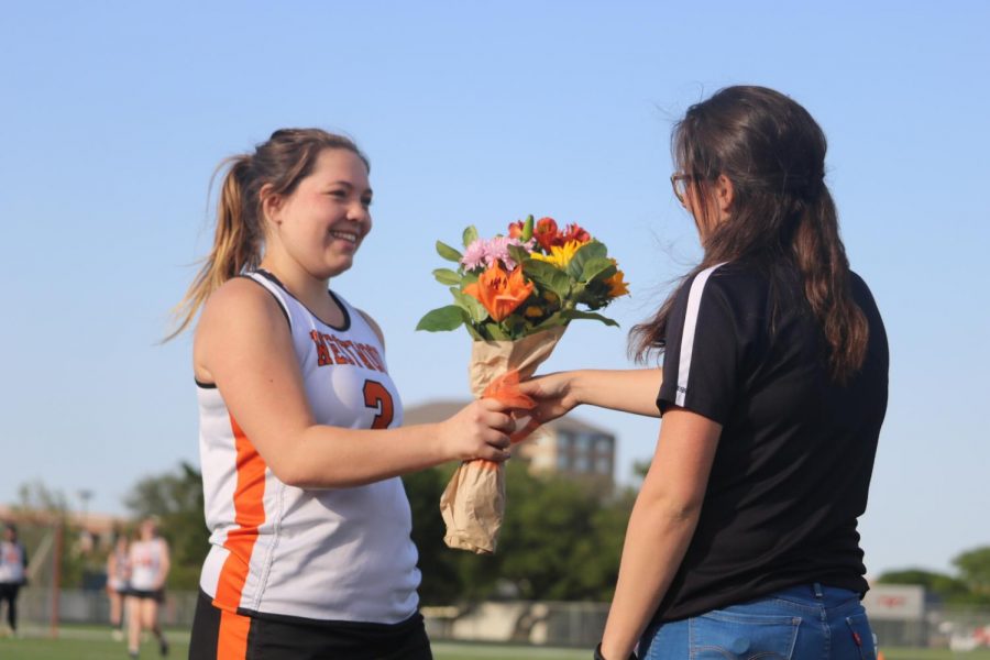 Emma Bontempo 18 receives flowers from her coach. 
