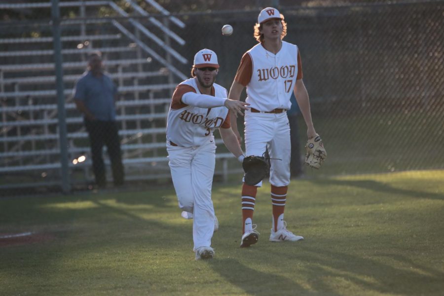 Jackson Melton 18 throws the ball to a waiting teammate at first base.