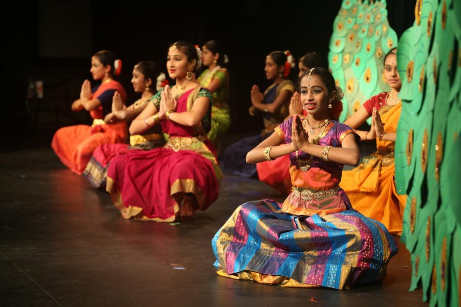 Performers don traditional Indian clothing while dancing. 