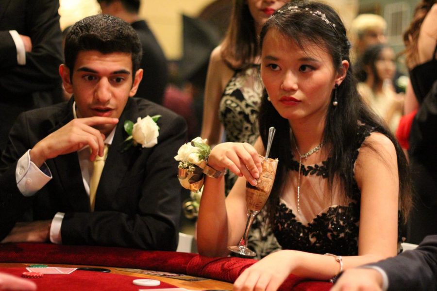 A pair of students play poker together.