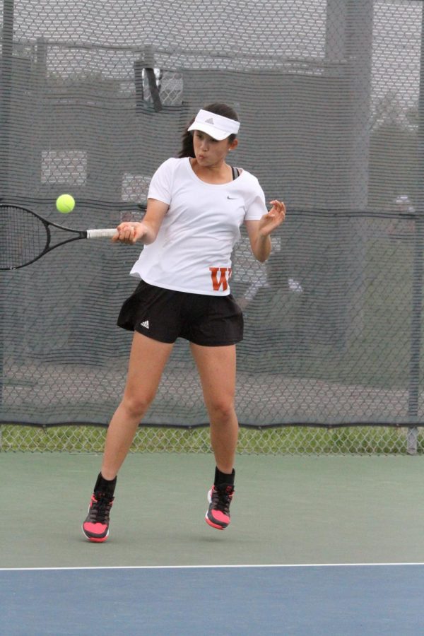 Jessica Lu 21 meets the ball with a forehand return.