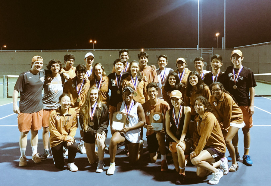 The team poses with their district title and individual medals. Photo courtesy of Westwood Tennis. 