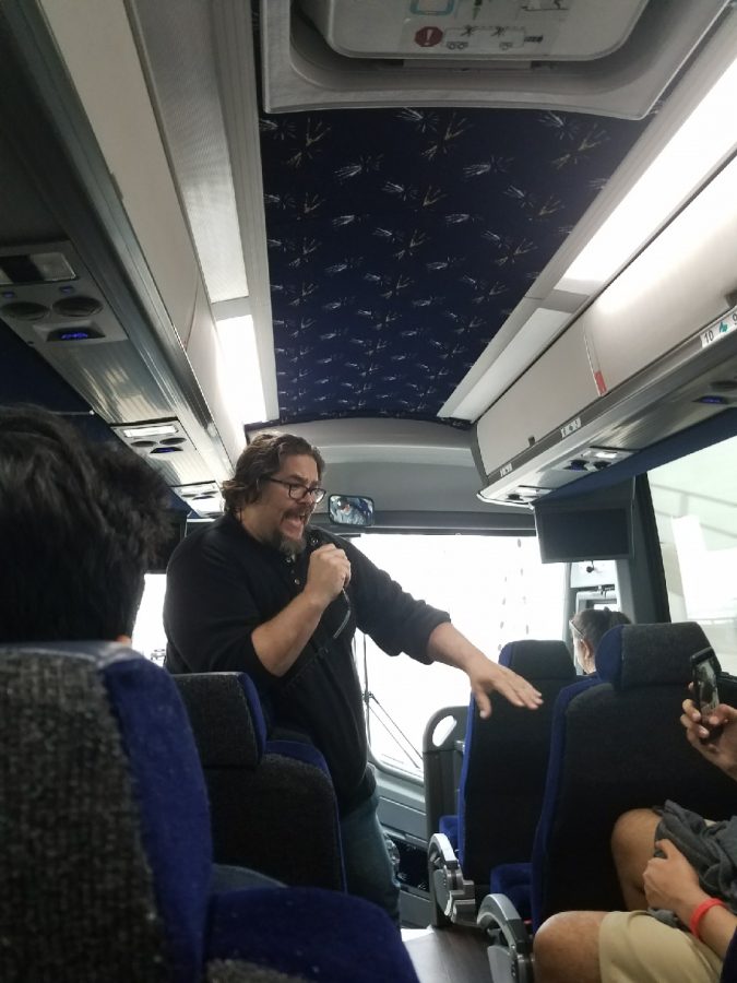 Mr. Christopher Bryant entertains students on a long bus ride.