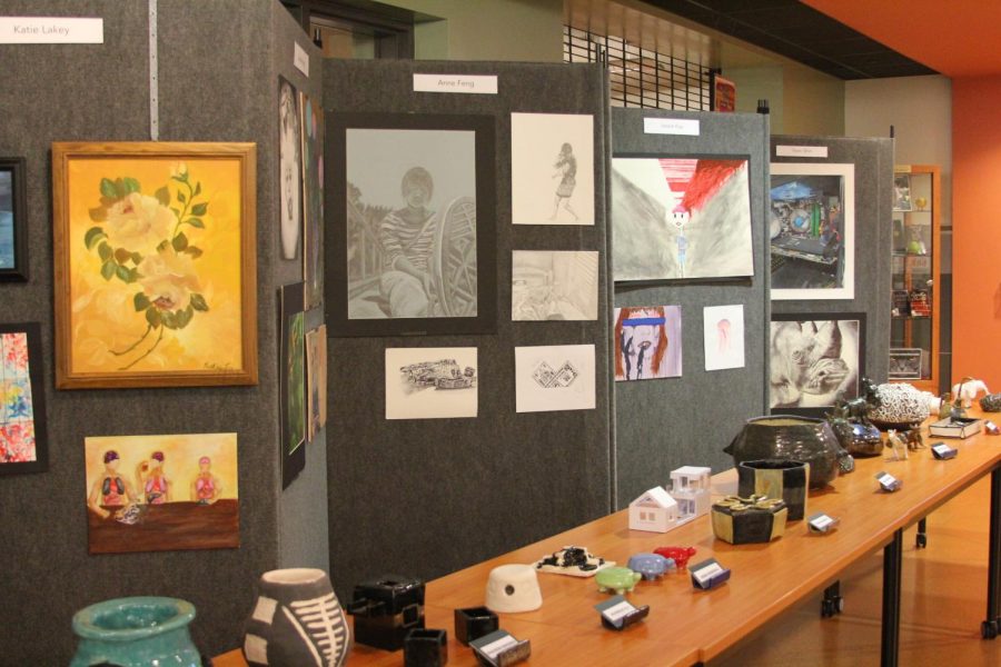 Paintings and ceramics are displayed.