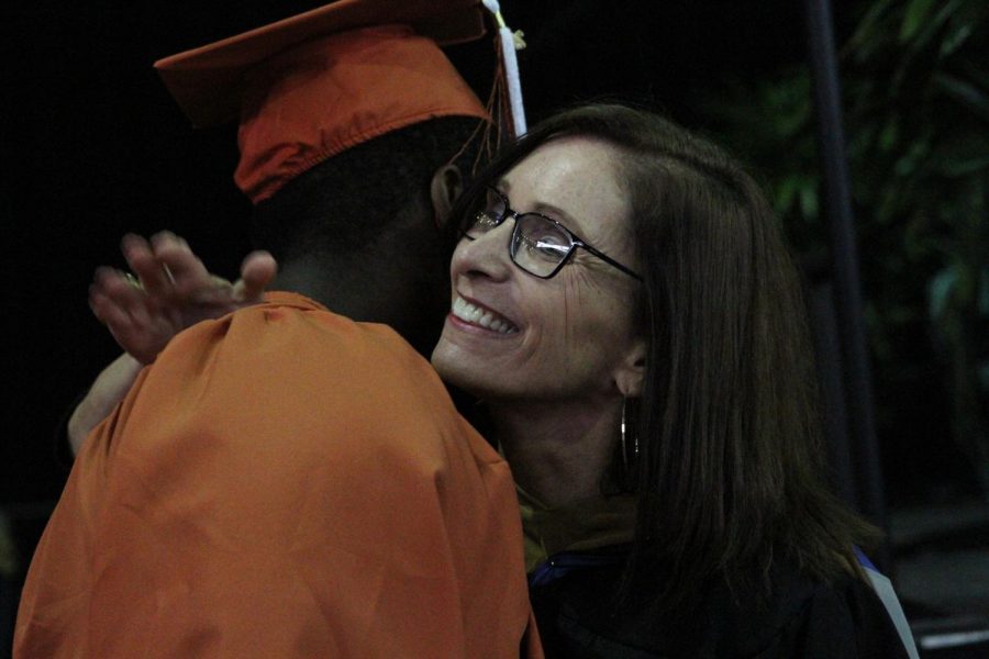 Ms. Camardo shares a hug with a senior before he receives his diploma. 