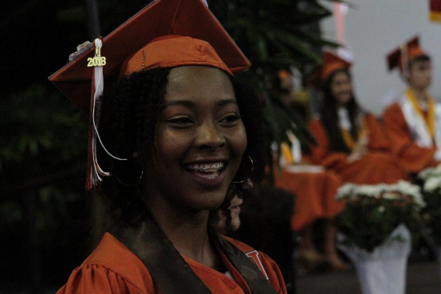 A student smiles before going on stage to receive her diploma. 