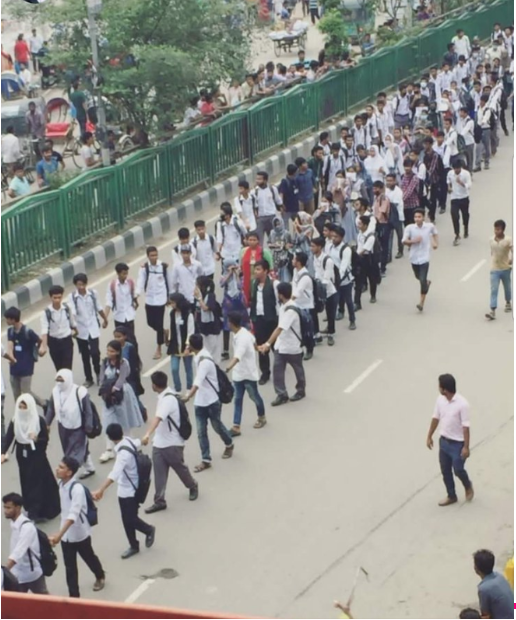 Teenage boys create a pathway to protect the young girls protesting after four girls were raped brutally by the Bangladesh Chhatra League (BCL). 