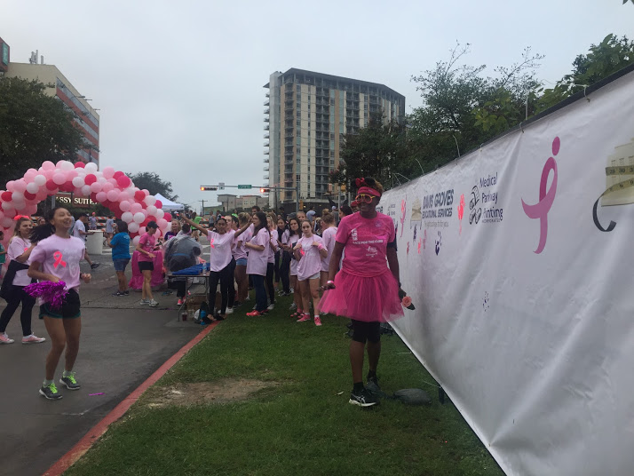 A breast cancer survivor dresses from head to toe in all pink.