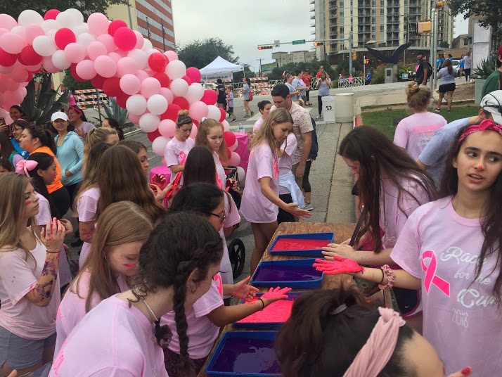 At the end of the race, students dunk their hands in paint in order to leave their mark for a friend or family member that has had breast cancer.