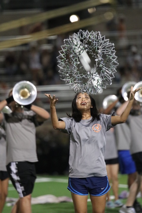 April Gao 20 throws a silver ball during the half time performance.