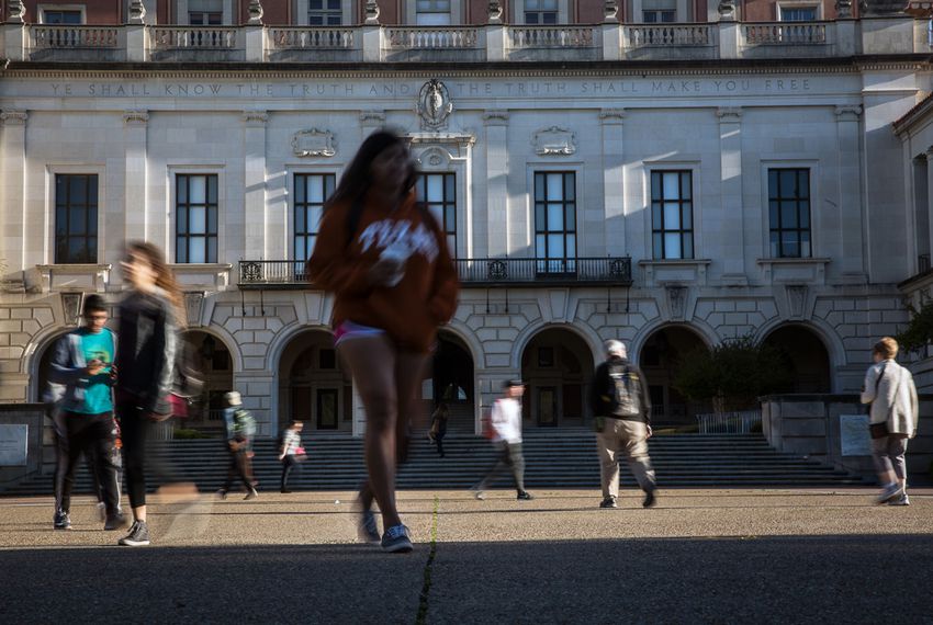 Students walk to class on the campus of the University of Texas at Austin.
