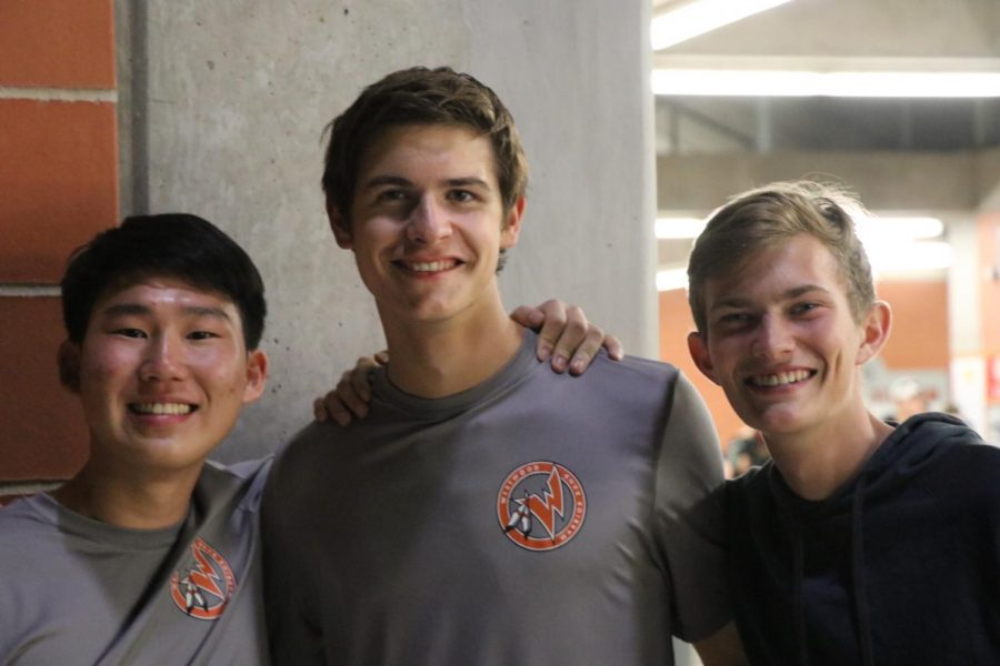 (Left to right) Seniors Andrew Ji, Zach Castles, and Justin Carver smile before their performance.
