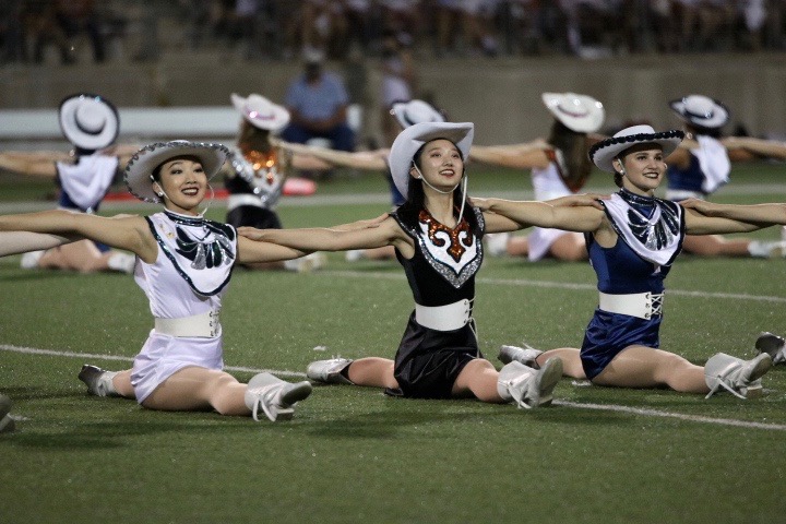 Emily Lu 20 does the splits along with the McNeil Majestics. 
