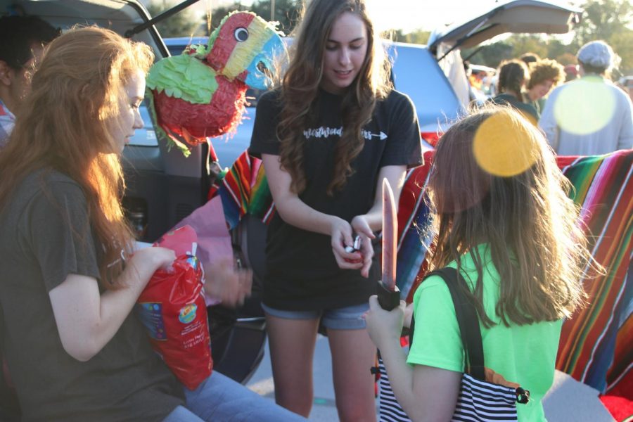 Sarah Armosky 20 and Sophia Norton 19 pass out candy at the choir trunk. 