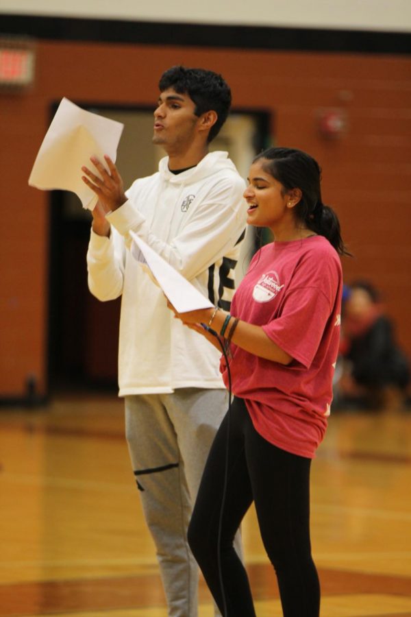 Senior Class President Shruthi Nampoothiri 19 and Avi Kacker 19 clap for the organizations at the pep rally.