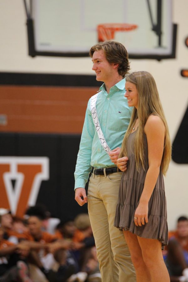 Hayden Hashem 19 is escorted by Abby Cook 20 as they smile to the crowd.